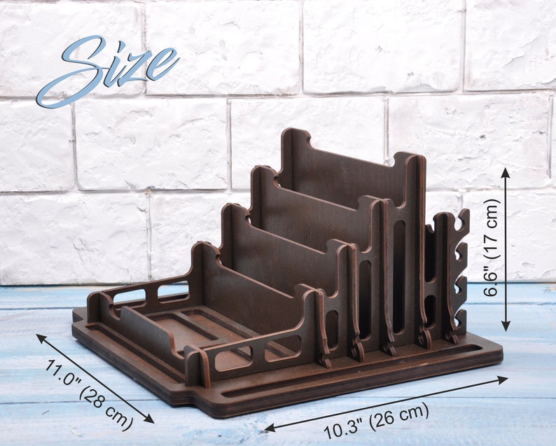 May include: A dark brown wooden stand with five slots for organizing items. The stand measures 11.0 inches wide, 10.3 inches deep, and 6.6 inches tall.  The stand has a small shelf at the bottom and a series of hooks on the side.