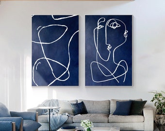 May include: Two rectangular wall art pieces featuring white continuous line drawings on a deep navy blue background. The left canvas displays abstract looping shapes, while the right canvas depicts a stylised human face profile in white lines.