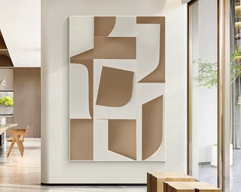 May include: Abstract art print featuring geometric shapes in shades of brown and white. The print is framed and hanging on a white wall in a modern interior.