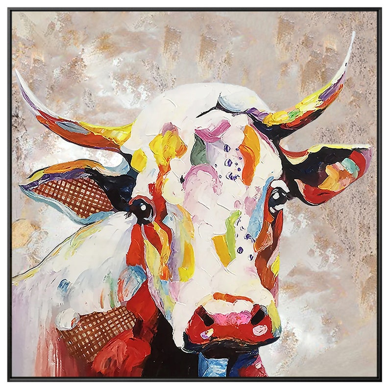 May include: A colorful abstract painting of a cow's head. The cow is white with splashes of red, yellow, green, blue, and purple paint. The background is a muted beige.
