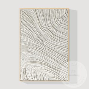 May include: A rectangular, textured white abstract art piece in a gold frame. The artwork features a flowing, wave-like pattern with raised lines, creating a sense of depth and movement. The piece is a modern, minimalist design.