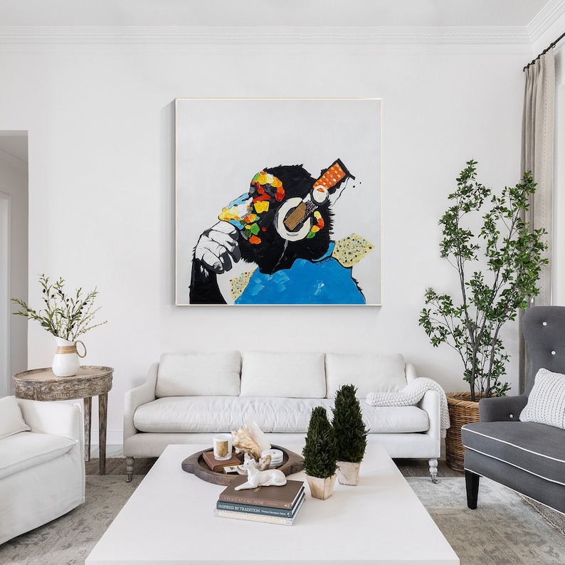 May include: A colorful abstract painting of a monkey wearing headphones. The monkey is painted in a vibrant style with splashes of blue, green, yellow, and orange. The background is white.