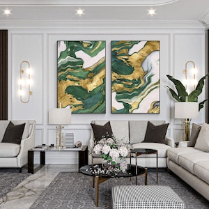 May include: Two rectangular wall art pieces featuring an abstract marbled pattern in shades of deep forest green, white, and metallic gold. The artwork is displayed side-by-side, showcasing fluid, swirling lines and organic shapes that create a cohesive visual composition across both framed panels.