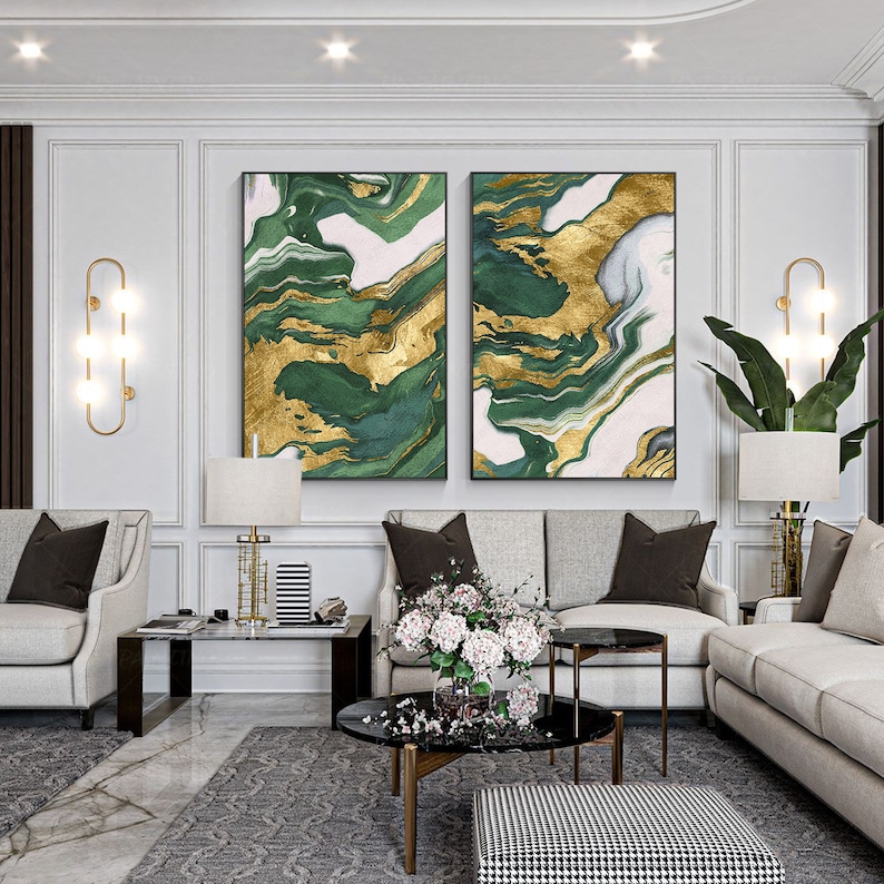 May include: Two rectangular wall art pieces featuring an abstract marbled pattern in shades of deep forest green, white, and metallic gold. The artwork is displayed side-by-side, showcasing fluid, swirling lines and organic shapes that create a cohesive visual composition across both framed panels.