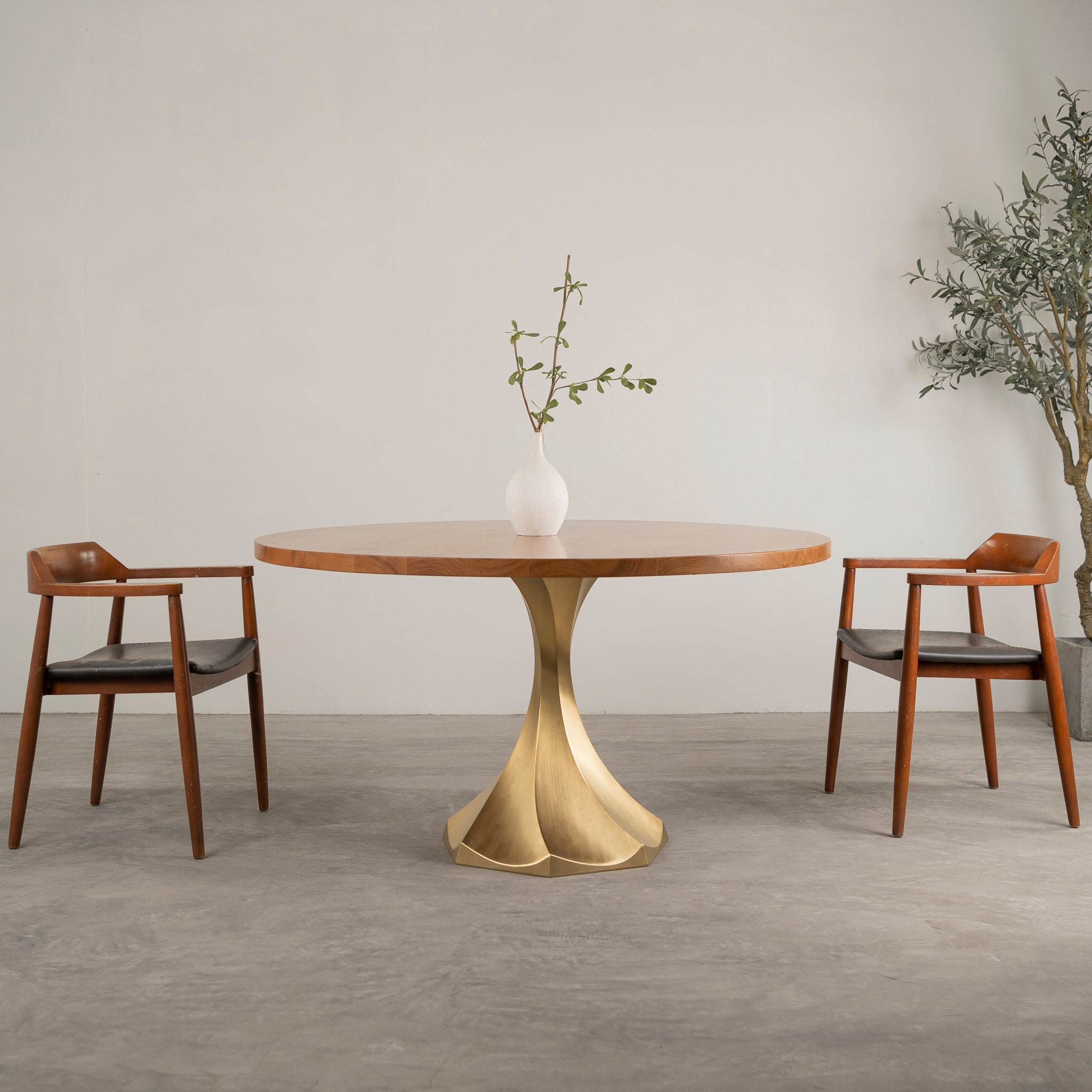 Round dining table with outlet brass base