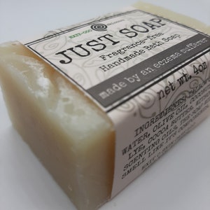 May include: A bar of handmade soap with a label that reads "JUST SOAP". The label also states the soap is fragrance-free and made for eczema sufferers. The net weight is 113 grams.