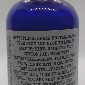 May include: A blue plastic bottle with a white cap and a white label. The label has the text "DIRECTIONS: SHAKE BOTTLE, SPREAD OVER FACE AND NECK TO LOOSEN MAKEUP/DIRT. WIPE OFF WITH COTTON PAD. WASH WITH EXITZEROskincare's FOAMING FACE-WASH, RINSE WITH WARM WATER. INGREDIENTS: FRACTIONATED COCONUT OIL, ALOE VERA GEL, WITCH HAZEL USP, SEA KELP BIOFERMENT, (LAVANDIN ABRIALIS, LEMONGRASSI VITAMIN E, ESSENTIAL OILS EXIT O SKIN CARE LLC 731 TOWNBANK RD CAPE MAY, NJ 08204 (518)414-1188 SHAKE WELL! USE WITHIN 1 YR."