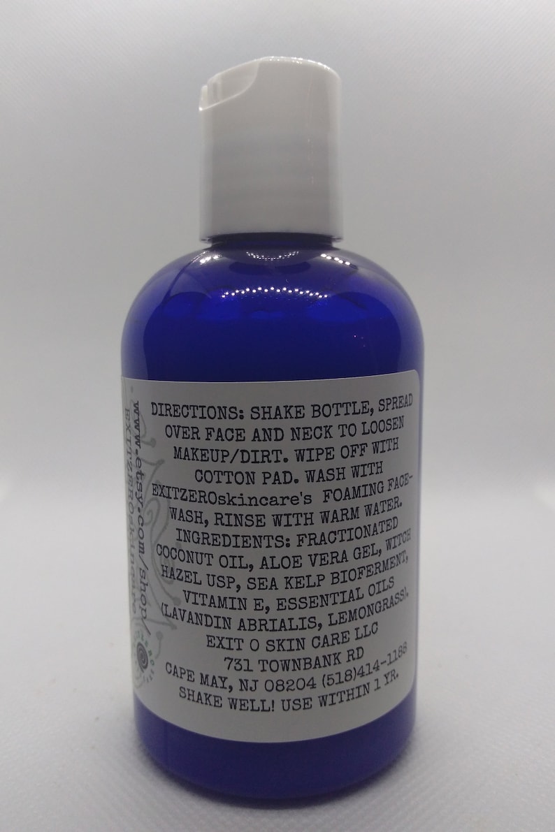 May include: Blue plastic bottle with a white cap and a white label with black text. The label includes directions for using the product, a list of ingredients, and contact information for the company. The text on the label reads: "DIRECTIONS: SHAKE BOTTLE, SPREAD OVER FACE AND NECK TO LOOSEN MAKEUP/DIRT. WIPE OFF WITH COTTON PAD. WASH WITH EXITZEROskincare's FOAMING FACE-WASH, RINSE WITH WARM WATER. INGREDIENTS: FRACTIONATED COCONUT OIL, ALOE VERA GEL, WITCH HAZEL USP, SEA KELP BIOFERMENT, VITAMIN E, ESSENTIAL OILS (LAVANDIN ABRIALIS, LEMONGRASS) EXIT O SKIN CARE LLC 731 TOWNBANK RD CAPE MAY, NJ 08204 (518)414-1186 SHAKE WELL! USE WITHIN 1 YR."