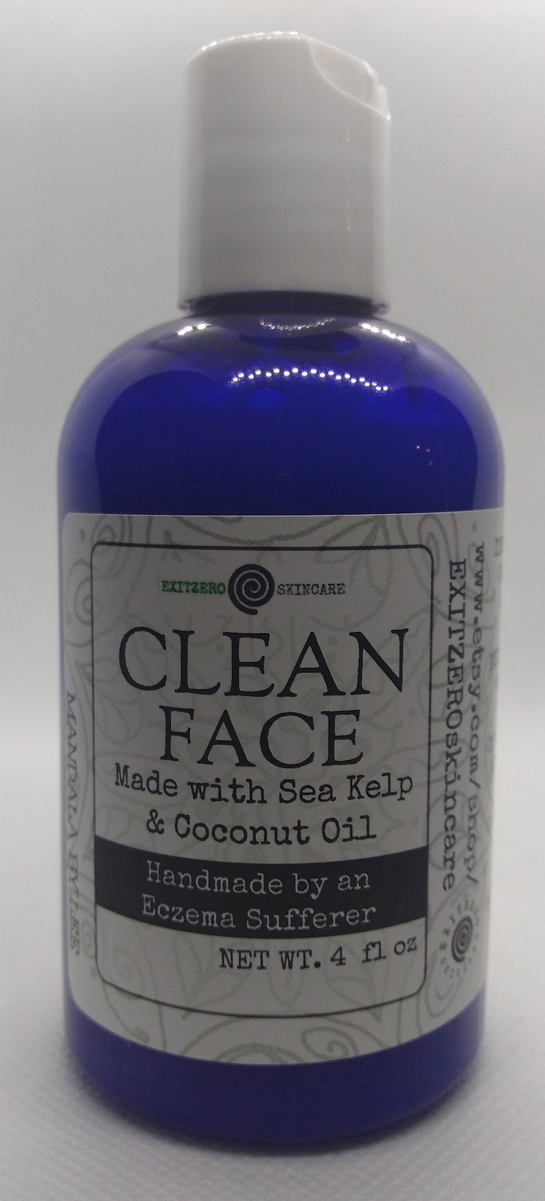 May include: A blue bottle with a white cap and a white label that reads "CLEAN FACE Made with Sea Kelp & Coconut Oil Handmade by an Eczema Sufferer NET WT. 4 fl oz"