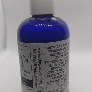 May include: A blue plastic bottle with a white cap, labeled "Ocean Face" with a list of ingredients including coconut oil, aloe vera, and sea kelp. The bottle is 4 fl oz and is labeled "EXITZEROskincare" with a website address and instructions for use.