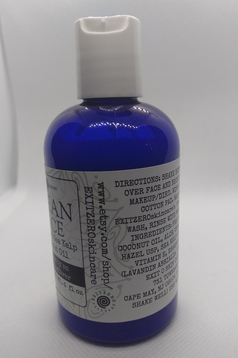 May include: A blue plastic bottle with a white cap, labeled "Ocean Face" with a list of ingredients including coconut oil, aloe vera, and sea kelp. The bottle is 4 fl oz and is labeled "EXITZEROskincare" with a website address and instructions for use.