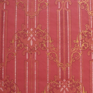 May include: Red wallpaper with a repeating pattern of gold-coloured vertical stripes and ornate floral designs. The wallpaper has a subtle textured surface.