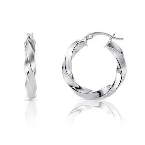 May include: A pair of silver twisted hoop earrings. The earrings are made of a thick, twisted metal and have a simple, elegant design.