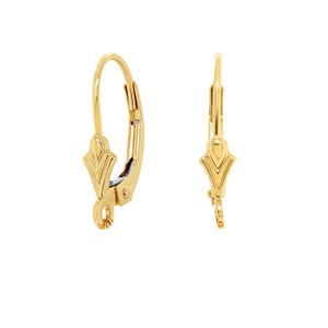 May include: A pair of gold-tone earring findings with a decorative, geometric design. The findings are made of metal and have a hook closure.