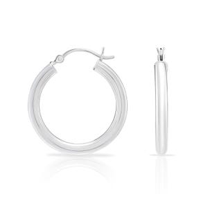 May include: Two silver hoop earrings. The earrings are round with a smooth, polished finish. The hoops have a classic design and are displayed against a white background. The earrings are a popular jewelry item.