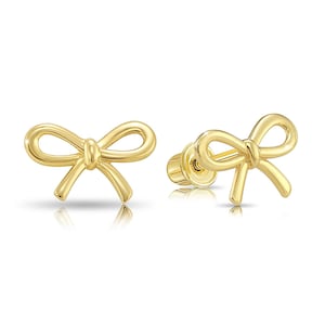 May include: A pair of gold bow-shaped stud earrings.
