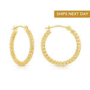 May include: A pair of yellow gold hoop earrings featuring a textured, braided surface pattern. The circular hoops are designed with a hinged post closure mechanism, showcasing a reflective metallic finish across the entire exterior of the jewelry.