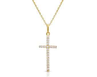 Könnte beinhalten: Eine goldfarbene Halskette mit einem Kreuzanhänger. Das Kreuz ist mit kleinen, funkelnden Steinen besetzt. Die Halskette hängt an einer zarten Kette und erzeugt ein schlichtes, aber elegantes Design.