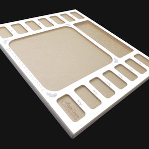 Angled corner view of the Acclaim Crafts Seed Beaders Dream Board with its smooth white surface, graphics, and rounded edges.