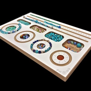 The PortaBracelet Wood Beading Board by Acclaim Crafts for compact work spaces and for making bracelets while traveling!  Stock #40013.