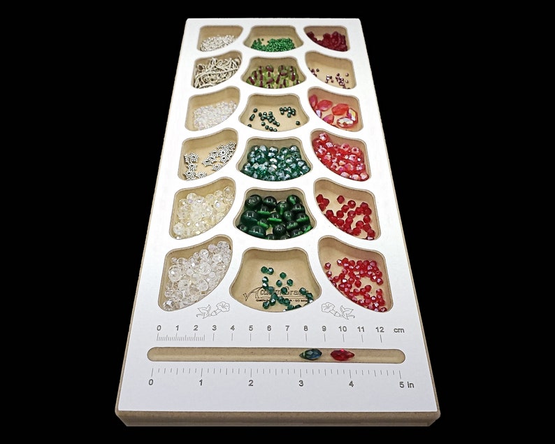 Acclaim Crafts Bead Stringers Pocket Board, 6 3/8 x15x3/4", with a clean white surface, 18 pockets, and a handy measuring groove.