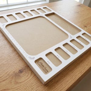 Perspective pic of the Acclaim Crafts Seed Beaders Dream Board shows the smooth surface, graphics, and layout of the pockets.