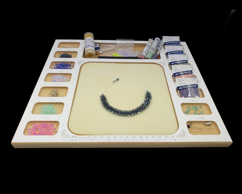 Low profile view of the Acclaim Crafts Seed Beaders Dream Board in use, filled with beads, supplies, and a finished bracelet.