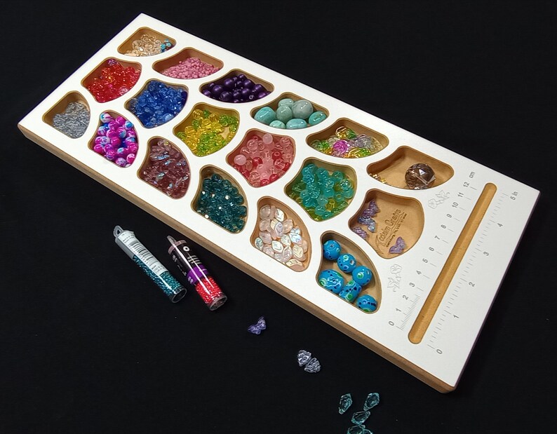 Acclaim Crafts Bead Stringers Pocket Board with various colorful beads, the deep pockets keep supplies separated yet accessible.