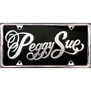 May include: A black license plate with a silver chrome frame and the words "Peggy Sue" written in a cursive script.