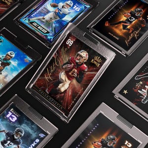 May include: A collection of encased sports trading cards featuring football players. The cards display action shots, player names, and team logos. Some cards have the text "Quarterback" and "Running Back". The cards are in protective cases.