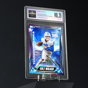 May include: A graded trading card featuring a football player in a blue and white uniform, holding a football. The card is encased in a clear plastic holder with the text "Thunderhawks" and "Colt Walker". The card is labeled "Vol. 28".