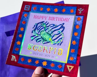 May include: A colorful birthday card with a Scorpio theme. The card features a green scorpion illustration, the words "Happy Birthday" and "Scorpio," and the dates Oct 23 - Nov 21. The card has a red and blue border with star accents.