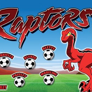 May include: A red and black soccer team banner with the words "Ruby Raptors 2024" and a cartoon red dinosaur. The banner also features the names of the players and the coach.