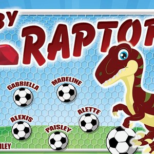 May include: A red and white soccer team banner with the words "Ruby Raptors" and the year "2024". The banner features a cartoon dinosaur kicking a soccer ball. The team roster includes the names Charlotte, Gabriella, Madeline, Opal, Alexis, Paisley, Alette, and Coach Ashley.