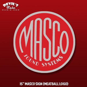 May include: A red circular sign with the word "MASCO" in large white letters. The words "SOUND SYSTEMS" are in white text at the bottom of the circle. The sign is 15 inches in diameter.