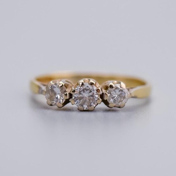 Solid 18K gold three stone diamond ring set in platinum