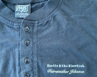 May include: Black long-sleeve shirt with a button-up placket and a white embroidered design that reads "Hootie & the Blowfish Fairweather Johnson".