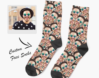 May include: A pair of crew socks featuring a repeating pattern of a smiling person wearing round green-tinted sunglasses. The socks have solid black heels and toes. To the left, a square photo shows the person and the text Custom Face Socks.