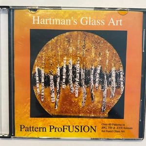 May include: A CD case featuring "Hartman's Glass Art." The cover displays a circular design of birch trees with white trunks and black markings against a golden background. The text "Pattern ProFUSION" is at the bottom.