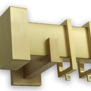 May include: Gold metal curtain rod with square end caps and brackets. The rod has a brushed finish.