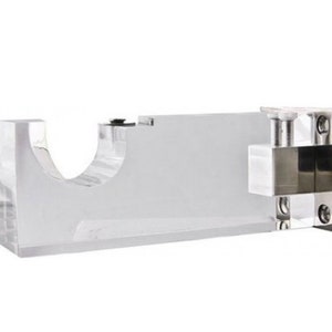 May include: Clear acrylic curtain rod bracket with a silver metal mounting plate and screws. The bracket has a curved opening for the rod to fit through.