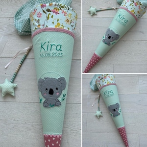 Könnte beinhalten: Ein grüner und rosa Schultüte mit einem Koalabären-Design. Die Tüte ist mit weißen Punkten verziert und hat den Namen "Kira" und das Datum "16.08.2025" aufgestickt.