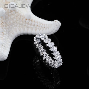 May include: A white ceramic mug with a black handle and the text "But First, Coffee" in a bold, black font. The mug is sitting on a wooden surface. The mug is approximately 4 inches tall.