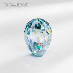 May include: A faceted crystal ball with a light blue hue and iridescent rainbow reflections.