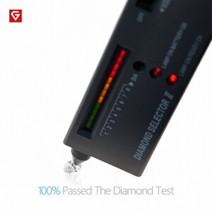 May include: A black diamond tester with a red light indicating that the diamond is real. The tester has a scale from 1 to 8 with a red light at 8. The text "DIAMOND SELECTOR II" is printed on the side of the tester. The text "100% Passed The Diamond Test" is printed below the tester.
