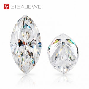 May include: Two clear, faceted gemstones. The larger gemstone is a marquise shape, while the smaller gemstone is round. Both gemstones are reflecting light.
