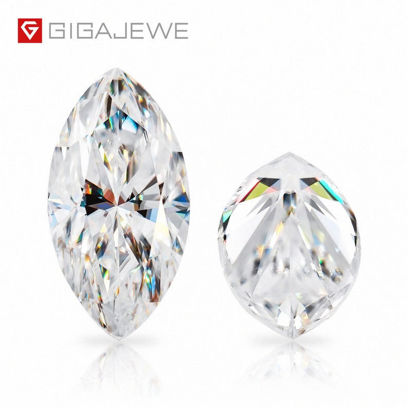 May include: Two clear, faceted gemstones. The larger gemstone is a marquise shape, while the smaller gemstone is round. Both gemstones are reflecting light.