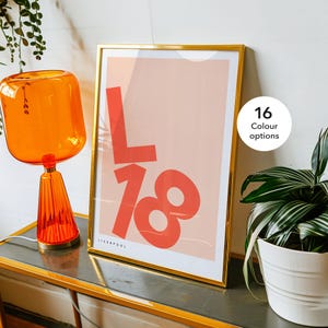 May include: A gold framed print with a pink background and red text that says "L18" and "LIVERPOOL". There are 16 colour options available.
