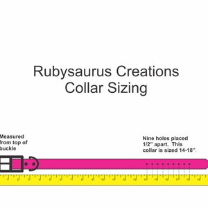 May include: A pink dog collar with a black buckle and nine holes spaced 1/2 inch apart. The collar is sized 14-18 inches.  Rubysaurus Creations Collar Sizing.