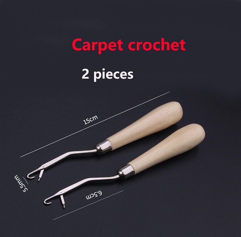 May include: Two carpet crochet tools with light-colored wooden handles and silver metal hooks. The text "Carpet crochet" and "2 pieces" is visible. One tool measures 15 cm in length, while the hook widths are labeled as 5.5 mm and 6.5 cm.